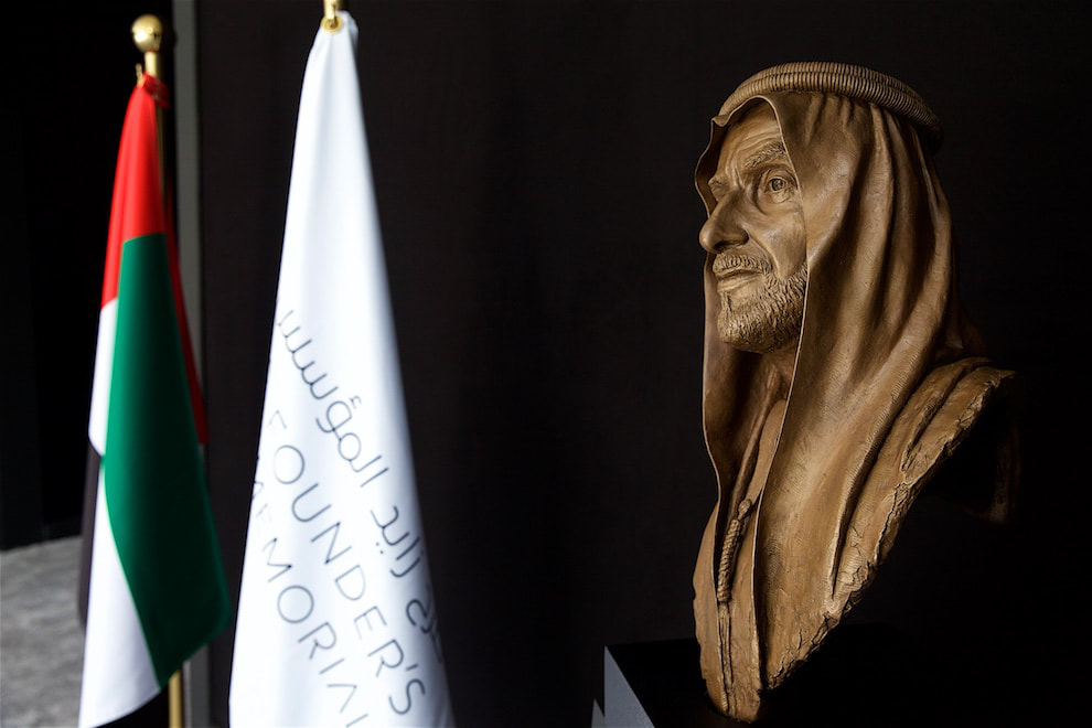 An image of a bust of HH Sheikh Zayed, with the UAE flag in the background